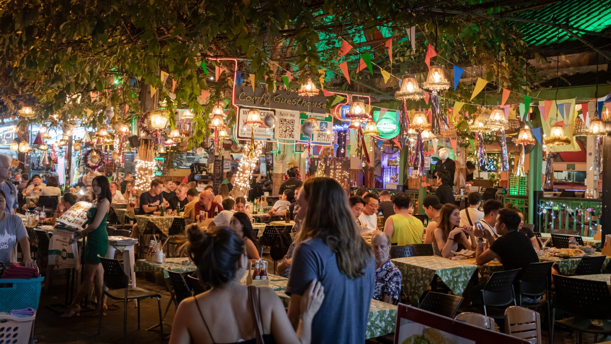 People in an open air restaurant at night time © Syed Ahmad
